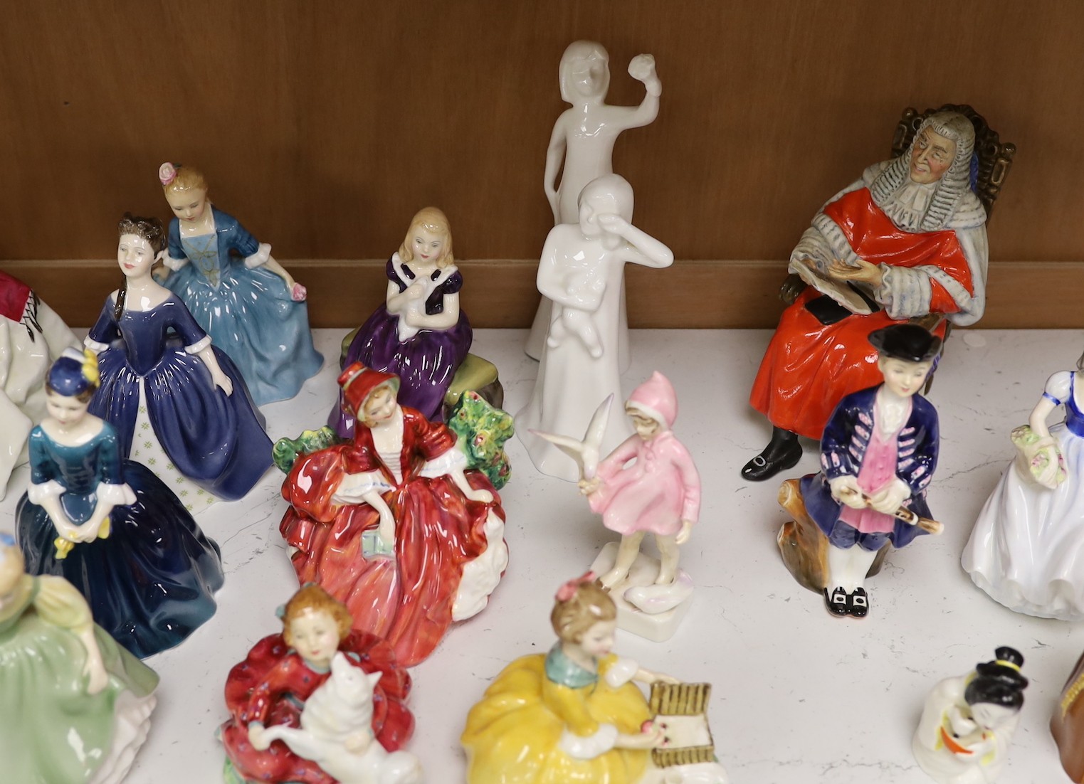 A collection of mostly Royal Doulton and Worcester figurines (22)